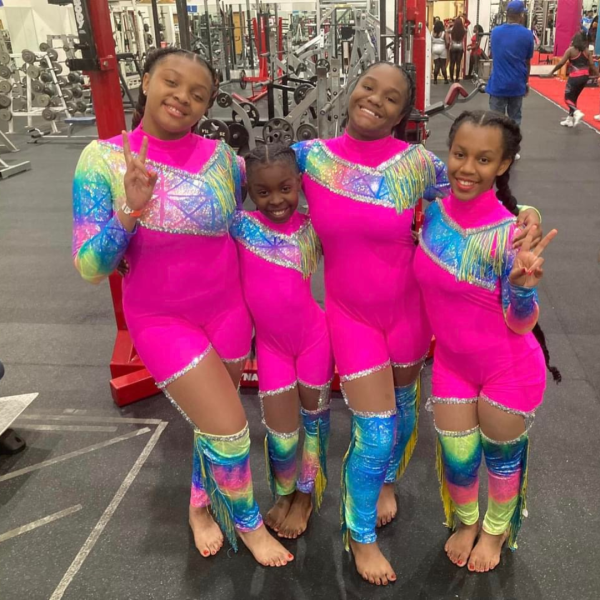 Four girls posing in their majorette uniforms